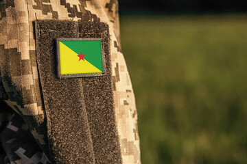 Close up millitary woman or man shoulder arm sleeve with French Guiana flag patch. French Guiana...