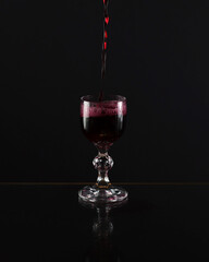 Glass on a black background. Vodka glass. A transparent glass for water or vodka. Glass cup