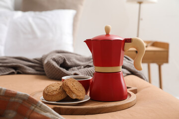 Fototapeta na wymiar Plate with geyser coffee maker, delicious cookies and cup of espresso on bed