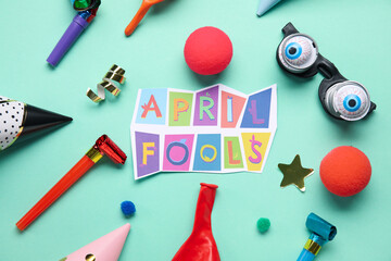 Composition with text APRIL FOOLS and party decor on color background