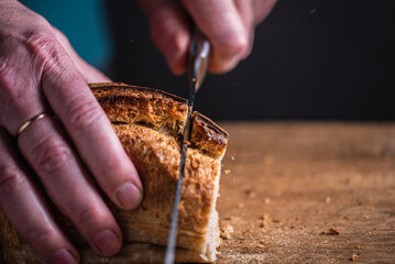 man cutting homemade bread