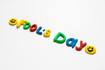 Text FOOL'S DAY made of plasticine on light background
