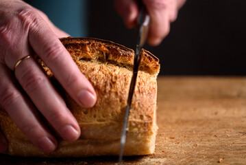Homemade bread. man cutting homemade bread