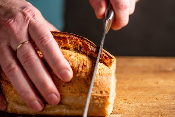 man cutting homemade bread