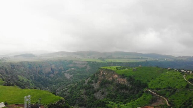 Dashbashi, Georgia - 19th june, 2022: Aerial fly over Diamond shape platform on glass bridge over scenic dashbashi valley in Georgia countryside. Famous modern bridge over valley in caucasus
