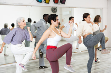 Fototapeta premium Group of people of different nationalities, engaged in a dance studio, learn sports dance in lesson