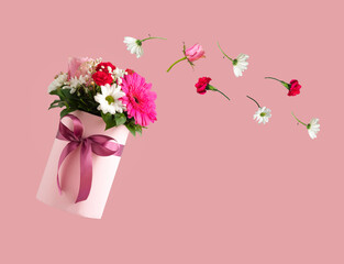 Pink gift box with various flowers on pink background. Valentines day aesthetic nature concept. 8 March card idea. 