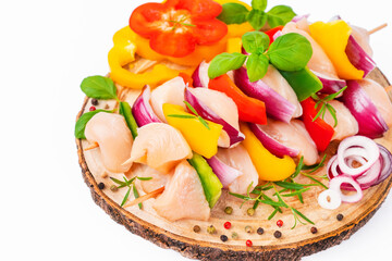 Chicken Skewers breast fillet meat.Uncooked mixed meat skewer.Skewers with pieces of raw meat,red,yellow,green pepper.Top view.Raw chicken skewers with vegetables,peppers,onions,on a white background.