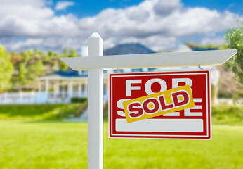 Sold For Sale Real Estate Sign in Front of New House.