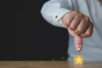 The man shows thumbs down or dislike. That is an evaluation. A cube has a star that means a bad job...