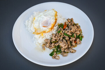 holy basil minced pork, Stir fried Thai basil with minced pork and a fried egg on white plate