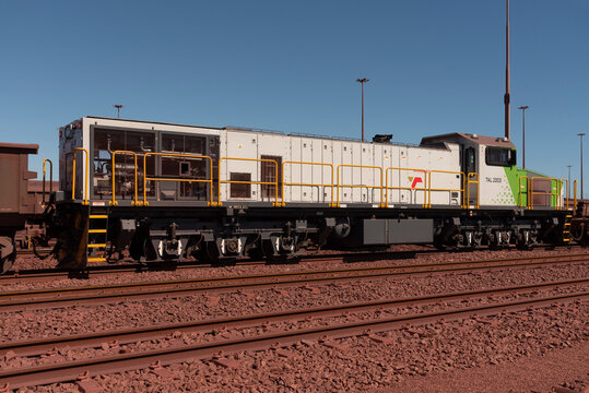 Saldanha Bay, west coast, South Africa. 2023. Locomotive hauling iron ore cargo in railway trucks through Saldanha Port before shipping out to China.