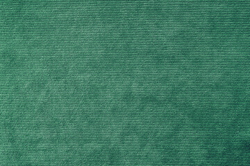 Texture background of velours green fabric. Upholstery velveteen texture fabric, corduroy furniture textile material, design interior, decor. Ridge fabric texture close up, backdrop, wallpaper.