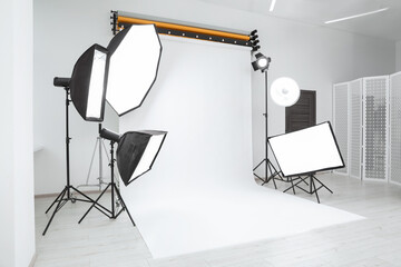 Interior of modern photo studio with professional lighting equipment