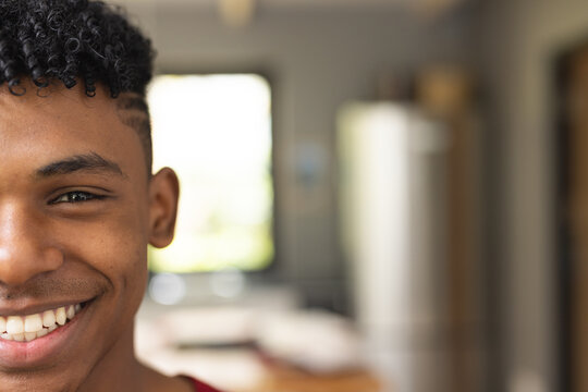 Image of face of happy african american teenage boy looking at camera