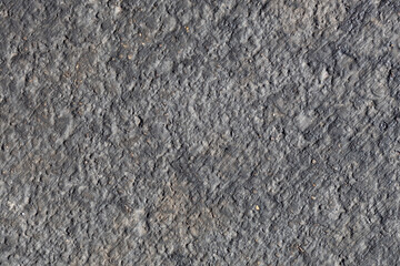 Full frame abstract texture background of an asphalt street surface, with natural texture and discoloration from weather and age