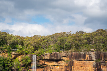 Fototapeta na wymiar Close-up view with a rainbow at Fitzroy Falls in Morton National Park in Kangaroo Valley, Southern Highlands, NSW, Australia.