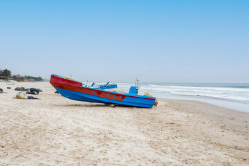 Montanita, Ecuador: 24-12-2022: small fishingboats are lying on the beach with the cleaned fishing nets lying alongside