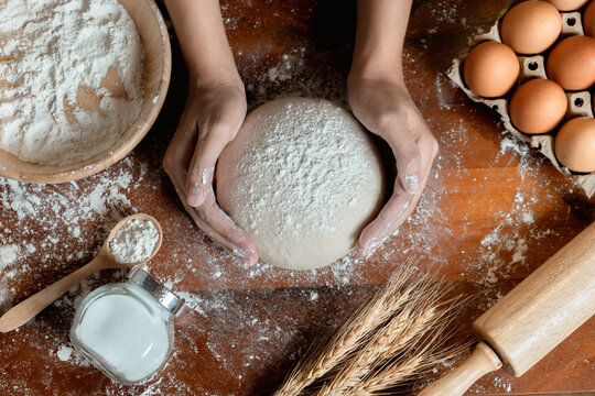Top View of Asian woman hands prepare and rest the dough before putting the Dough into the oven