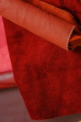  leather of red shades.Texture of red leather.surface of natural pieces of leather in burgundy and red tones. Genuine leather assortment. materials for making accessories,shoes and clothes