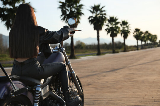 Woman Riding Motorcycle At Sunset, Back View. Space For Text