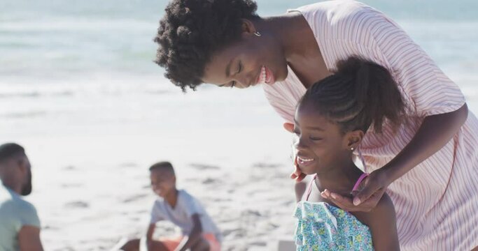 Video Of Happy African American Mother Putting Sunscreen On Her Daughter On Beach