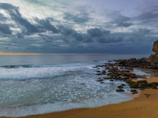 Fototapeta na wymiar Soft sunrise seascape with clouds and colour on the horizon