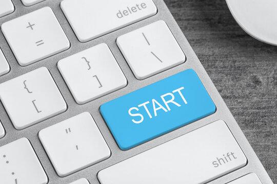 Light blue button with word Start on computer keyboard, closeup