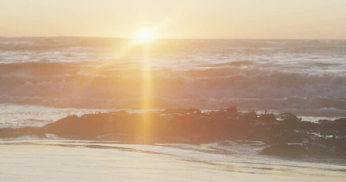 Video of calm sunset over ocean waves and beach