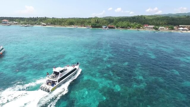 Speed boat foam in the sea going to Nusa Penida island, People holiday with speed boat in Sanur in Bali, Indonesia