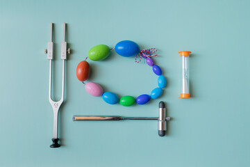 Orchidometer, neurological hammer and tuning fork lie on a blue background, medical instruments on...