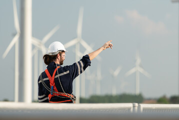 Engineer at Natural Energy Wind Turbine site with a mission to climb up to the wind turbine blades to inspect the operation of large wind turbines that converts wind energy into electrical energy