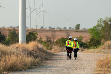 Man and female engineer stationed at the Natural Energy Wind Turbine site. with daily audit tasks...