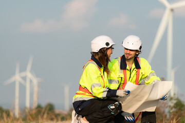 Man and female engineer stationed at the Natural Energy Wind Turbine site. with daily audit tasks...