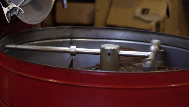 Industrial coffee roasting machine roasting a batch of coffee beans (4K)
