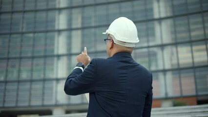 Real estate project manager or architect looking using tablet for checking and consultant to inspection in construction site building. Middle eastern Boss CEO, business owner Real estate property