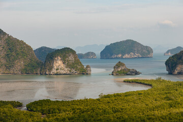 Samet Nangshe viewpoint at the south of Thailand during the daytime under the sunlight with the cloudy grey sky with the view of the rocks in Phang Nga Bay
 - Powered by Adobe