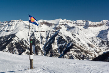 Colorado State Flag in the Rocky Mountains with Snow
