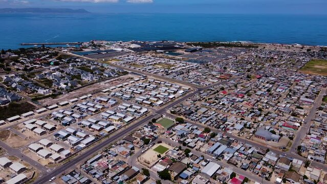 Vast coastal township in Hermanus - drone tilt-down view over Zwelihle