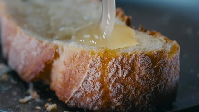 Erving honey on French toast. Sweet breakfast