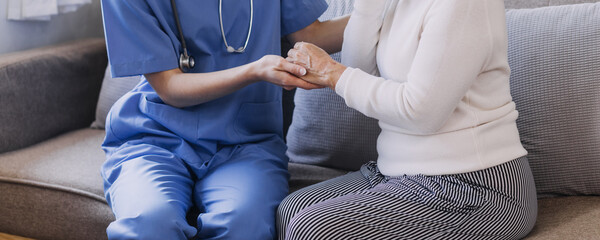 Homecare nursing service and elderly people cardiology healthcare. Close up of young hispanic female doctor nurse check mature caucasian man patient heartbeat using stethoscope during visit