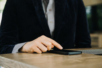 Mature businessman using a digital tablet to discuss information with a younger colleague in a modern business lounge