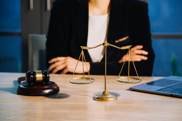 Justice and law concept.Male judge in a courtroom with the gavel, working with, computer and...