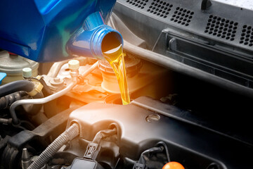 Refueling and pouring oil quality into the engine motor car Transmission and Maintenance Gear .Energy fuel concept.