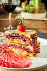 tasty sandwich with beef and wine