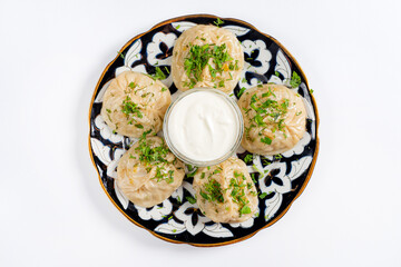 Georgian dumplings - Khinkali (Chinkali) with minced meat and herbs on a plate