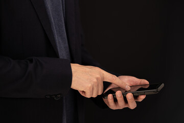 Close up of business man hand using mobile phone, searching the information during online working , internet networking, business planning, social media marketing