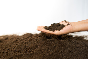 Farmer hand holding soil from fertile farm field