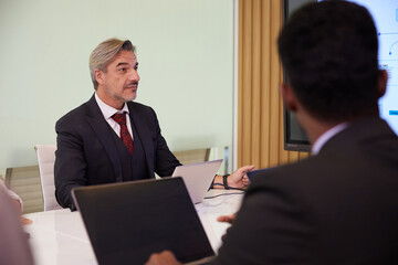 senior businesswoman meeting and looking to monitor in conference room