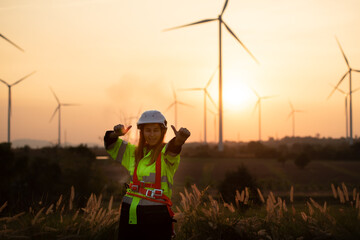Engineers working on wind farms for renewable energy are responsible for the maintenance of large wind turbines. Enjoy taking pictures with the sun shining in the evening.
